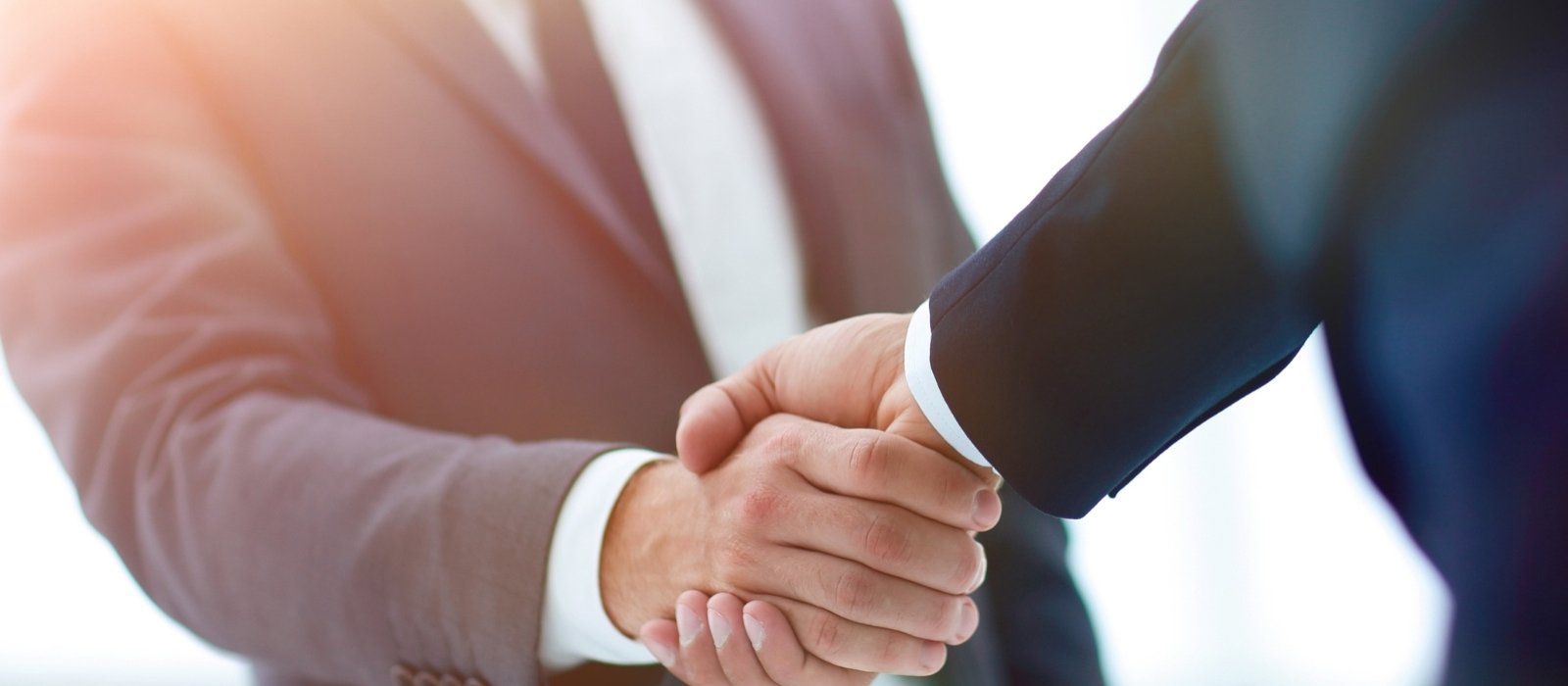 business people in suits shaking hands